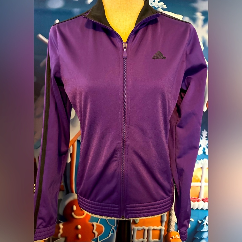 NWOT Adidas jacket in small with a purple color, 2 pockets on the side & zipper